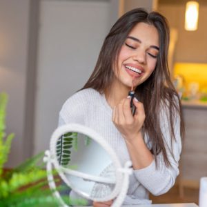 Beautiful,Young,Woman,With,Lipstick,On,Blurred,Background.,Smiling,Young